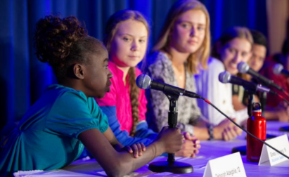 A 12-year-old girl discussing environmental issues with other inspiring young individuals, including Greta Thunberg, during a United Nations Committee event