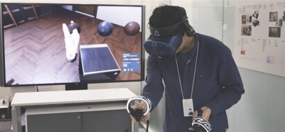 One of LG’s digital designers using a VR headset and remote control to better understand a product’s ability to harmonize with the environment.