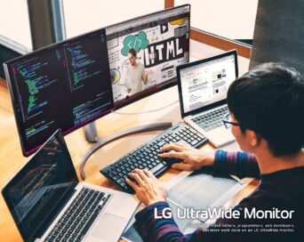 A computer programmer using the LG UltraWide Monitor with two laptops to multitask while working from home.