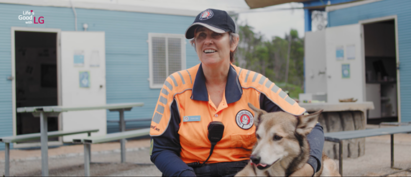 Adele Jago giving an interview about her work searching for missing people as a search dog sits on her lap.