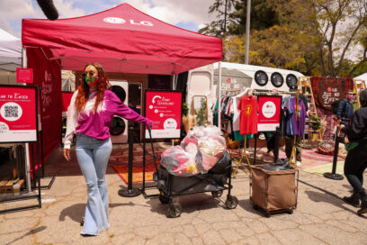 A woman pulling along several full bags of clothing ready to be donated to families in need.