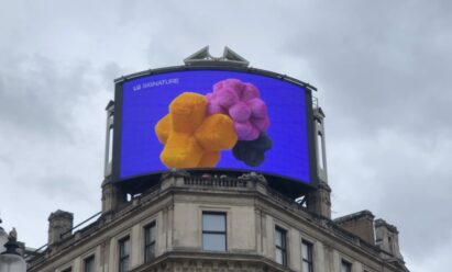 A close-up photo of LG's digital billboard in Piccadilly Circus, London with an animation representing LG SIGNATURE Washer and Dryer