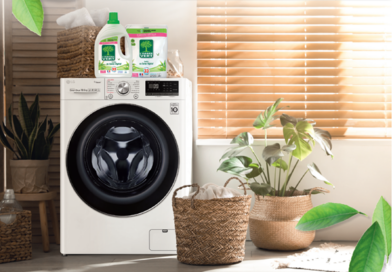 LG Washer with L’Arbre Vert’s detergent and fabric softener on top and green plants on both sides