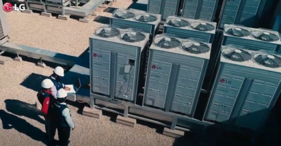 A screenshot from the LG HVAC Solutions YouTube video showing three men examining a building's LG Outdoor Units.