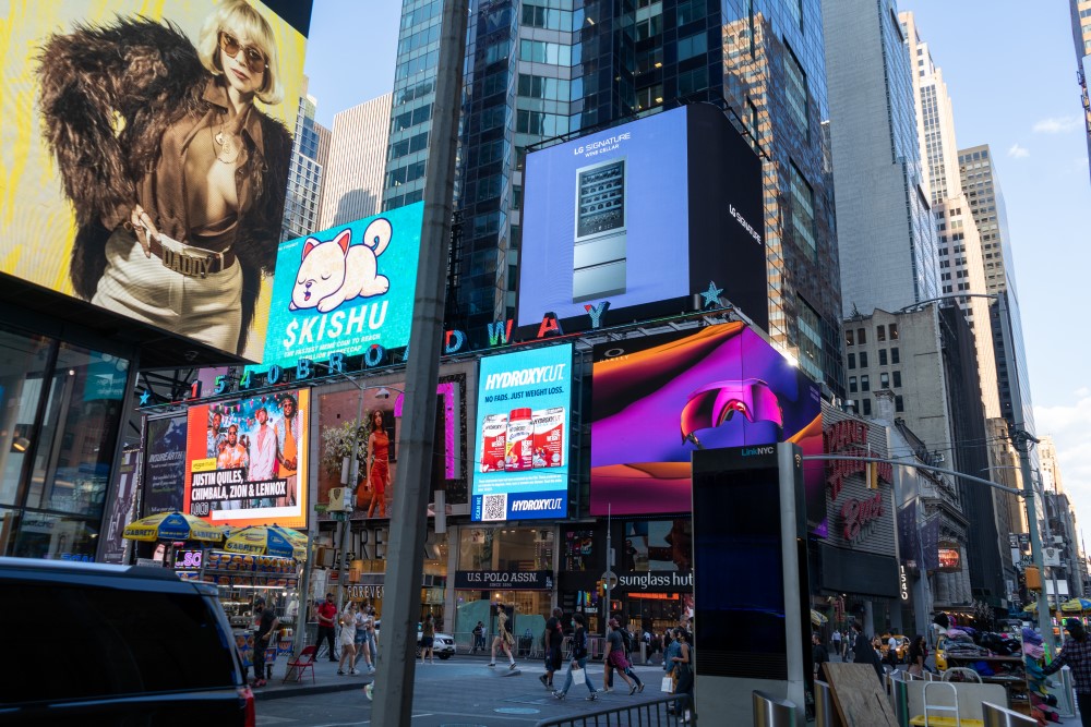 LG's digital billboard in Time Square, New York with an image of LG SIGNATURE Wine Cellar against a purple background