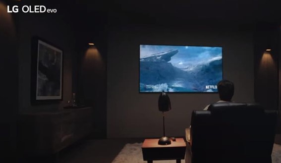 A man watching Netflix in his living room on LG OLED TV