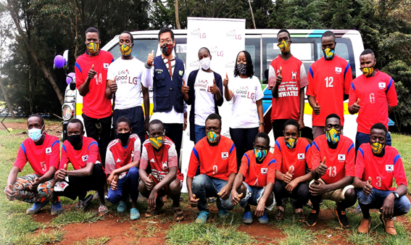 Players of the Limuru Soccer Academy pose with LG representatives in front of the van LG donated to the team