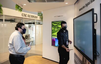 Two men experiencing the Interactive Digital Board installed at The LG Business Solution Center.