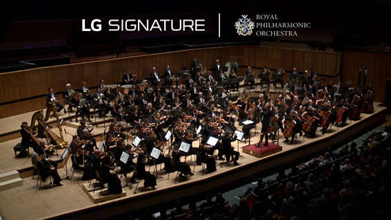 The Royal Philharmonic Orchestra playing in a concert hall with the logos of LG SIGNATURE and the orchestra above