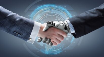 A man and a humanoid robot representing artificial intelligence shaking hands.