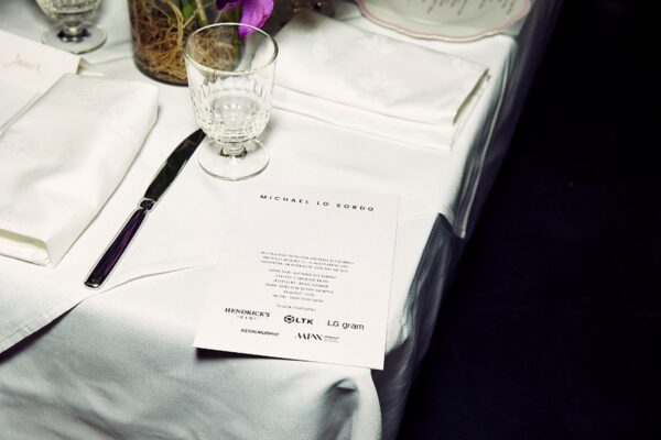 A close-up of a dining table featuring a greetings card with LG gram’s and Michael Lo Sordo’s names displayed.