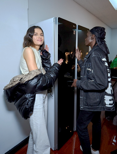 Two models posing with the LG Styler fitted backstage at the fashion show.