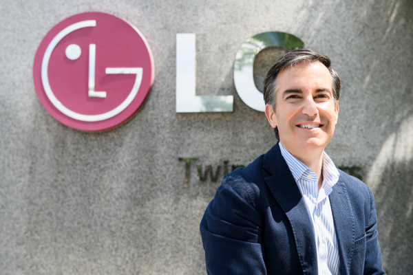 Carlos Olave, LG Global HR Leader, posing in front of the LG logo outside LG Twin Towers in Seoul. 