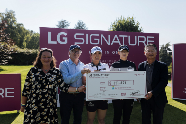 Justine Buisson, Franck Riboud, Ko Jin-young, Park Sung-hyun and Heaven Lee pose with a large check during the golf event to support online charity auction, 