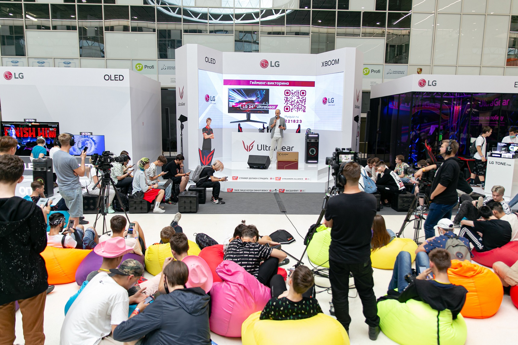 A large audience watches on as an LG representative makes a speech at the LG Electronics booth during Streamfest 2021.