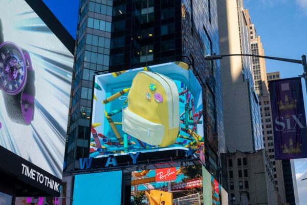 The Life’s Good Campaign video displaying a child’s backpack surrounded by crayons on the massive LG display in Times Square, New York City.
