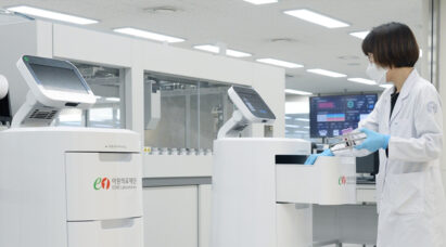 A scientist working with the help of LG CLOi ServeBot in the lab.