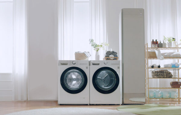LG washing machine and dryer in a bright expansive utility room next to LG Styler. 