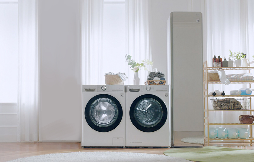 LG washing machine and dryer in a bright expansive utility room next to LG Styler.