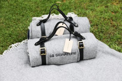LG SIGNATURE-branded picnic blankets on the grass.
