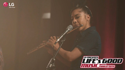 Sade Whittier, one of the winner is playing a flute.