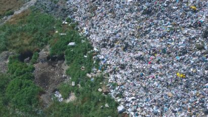 A bird's-eye view of an overflowing landfill site.