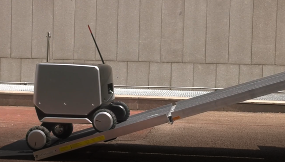 LG’s four-wheeled indoor-outdoor delivery robot moving up a steep ramp.