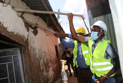 Ethiopian construction workers tearing down cracked walls for the Life’s Good: Hope Village campaign.