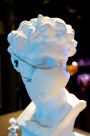 A close-up of a portrait bust wearing the LG PuriCare Wearable.