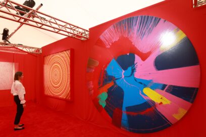 A visitor admiring the colorful artwork being vividly reproduced on LG OLED displays at an art exhibition