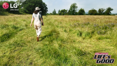 A screenshot from LG's Life's Good video showing Immy walking through a green field.