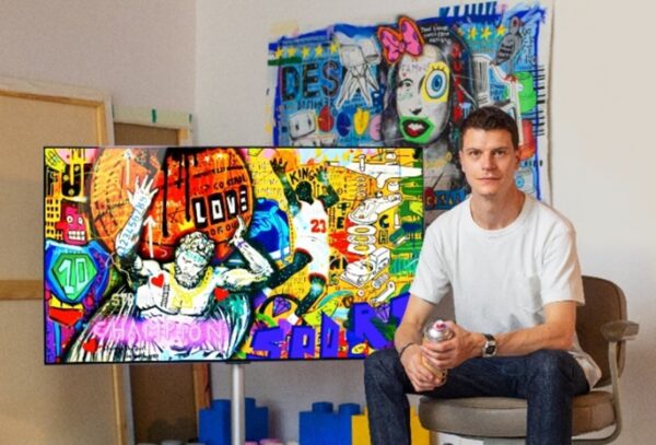 French pop street artist Jisbar with his artwork displayed on LG OLED TV.