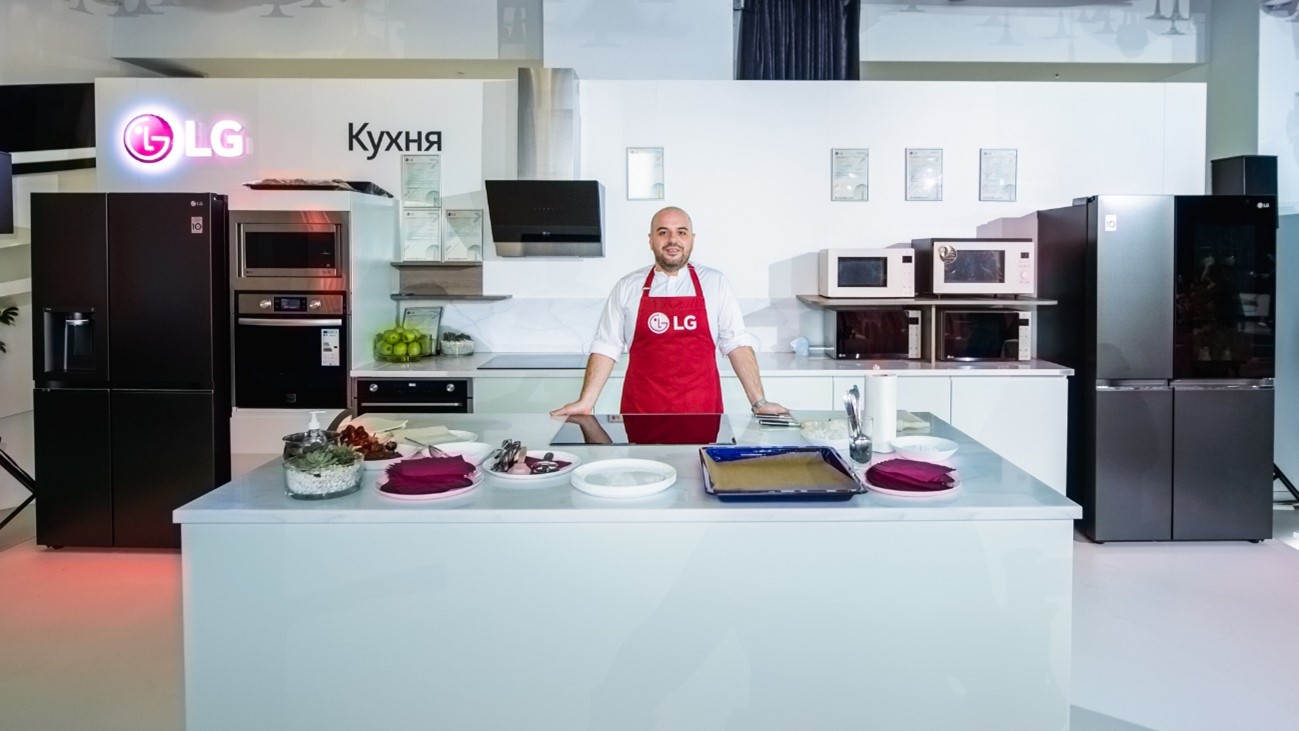 Chef Marco Prazzoli posing in the showroom kitchen fully equipped with various LG cooking appliances.