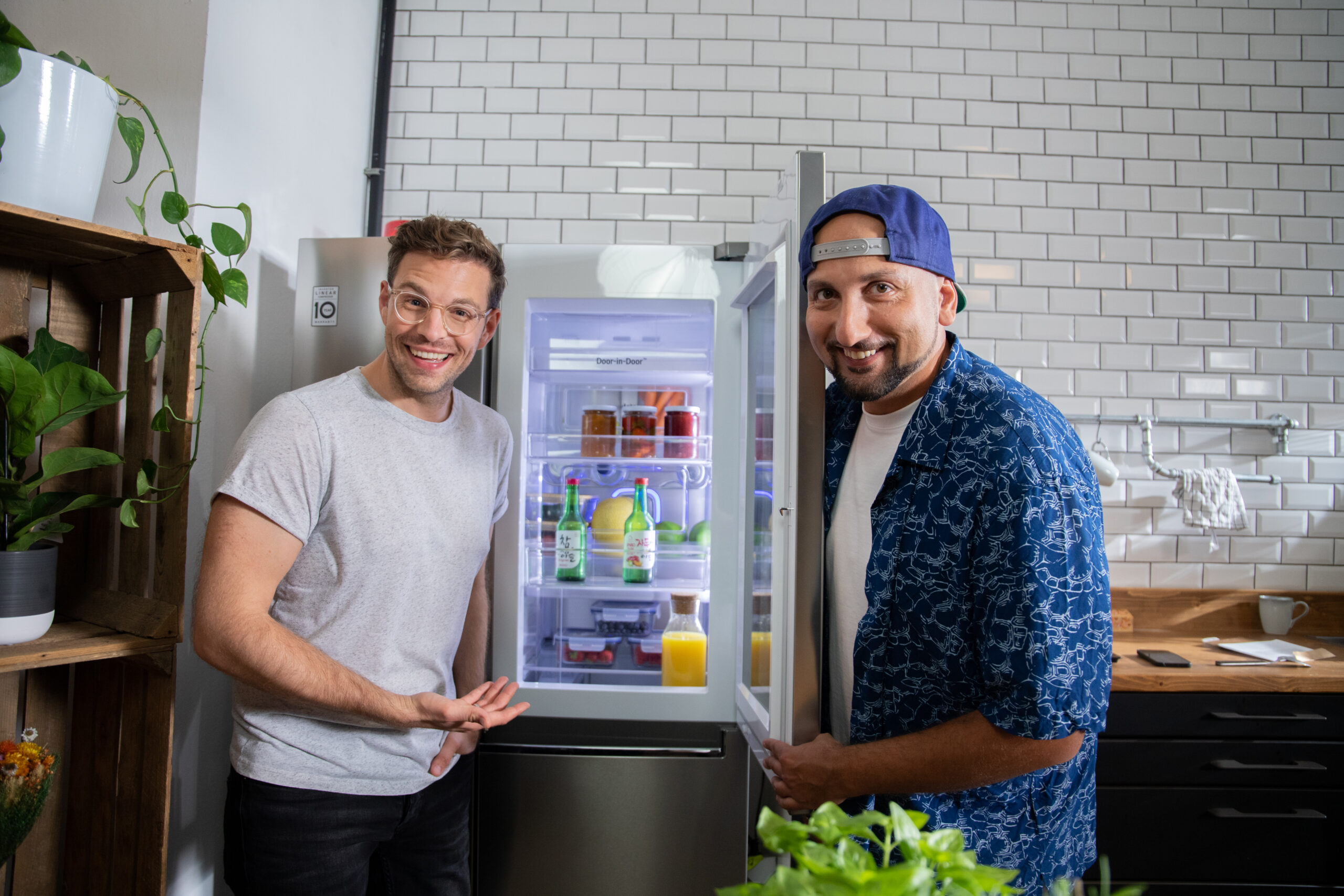 DJ Mosaken and Jakob Glanzer, the host of LG KitchenLife Stories, posing with the LG InstaView Door-in-Door refrigerator.