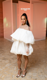 Misty Copeland, the renowned ballerina of the American Ballet Theatre, posing in a beautiful white dress in front of the LG SIGNATURE logo during the ABT Fall Gala.