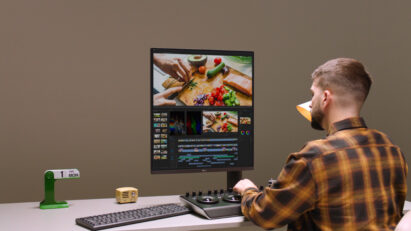 A man is editing a video with LG DualUp monitor