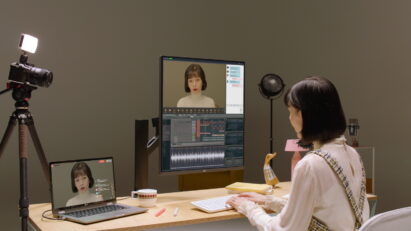 A woman is using an LG DaulUp monitor connected to a laptop with multiple windows opened