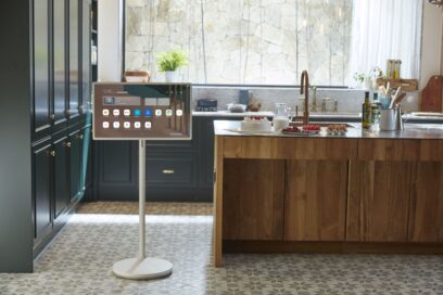 LG StanbyME standing in a kitchen as its screen displays useful information and apps.