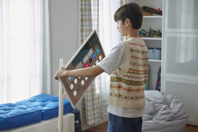 A boy rotating his LG StanbyME’s screen to view it in portrait mode.