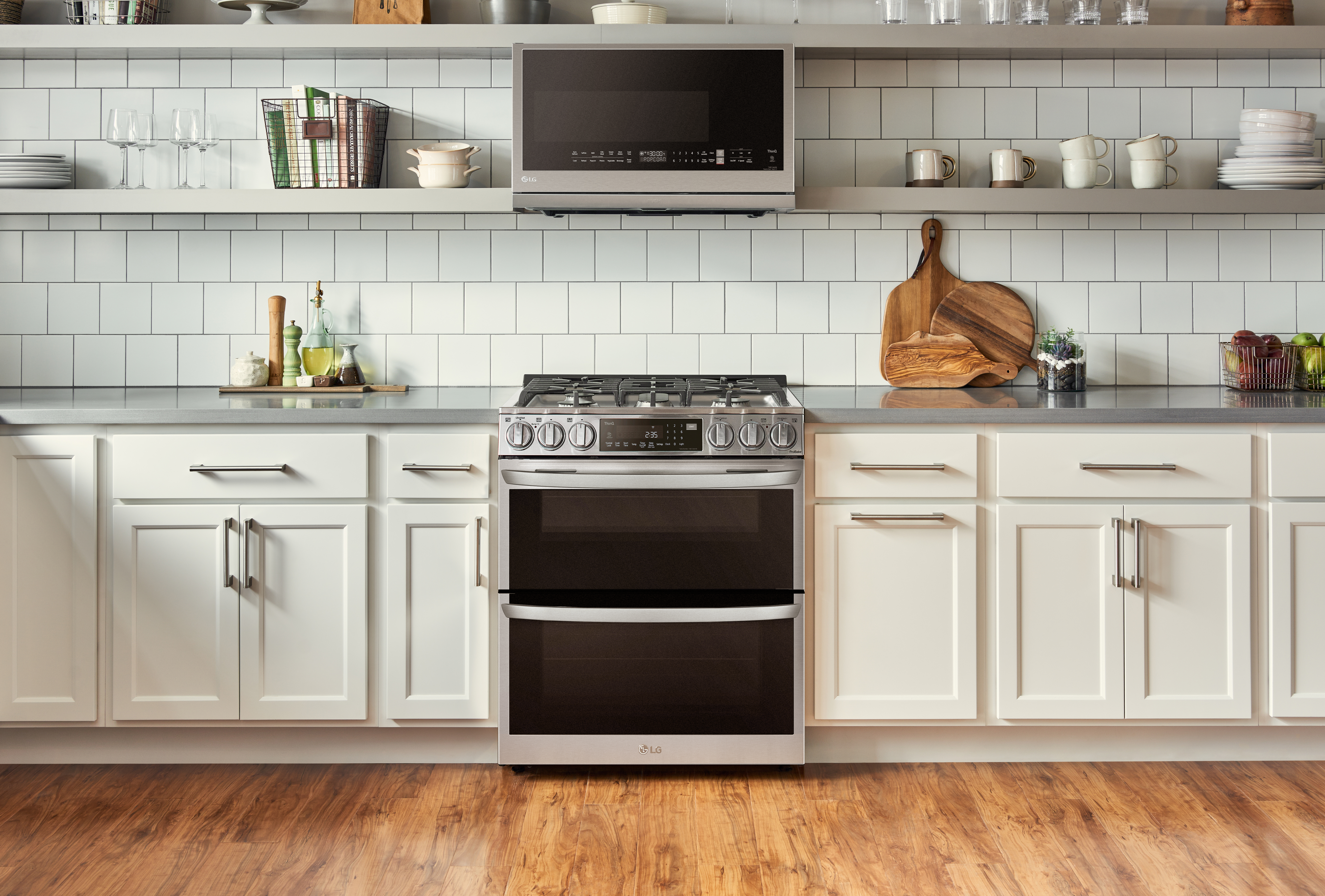 LG InstaView Double Oven Range and Over-the-Range Microwave Oven seamlessly harmonized in a bright kitchen.