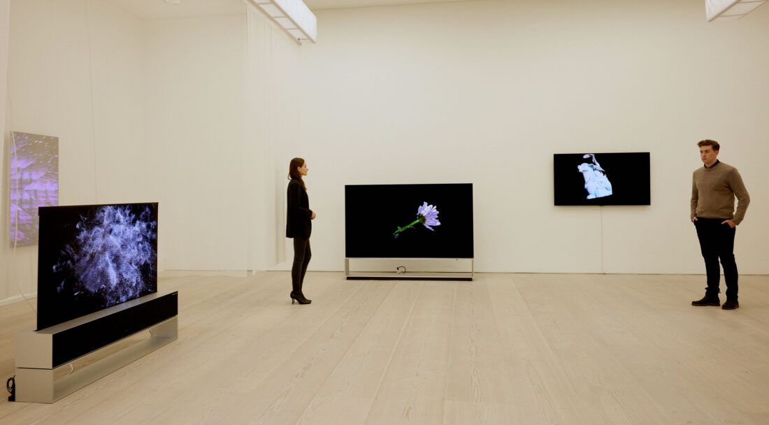 Two visitors viewing ‘The Moment & Morpho Luna’ by Je Baak displayed on LG OLED TVs