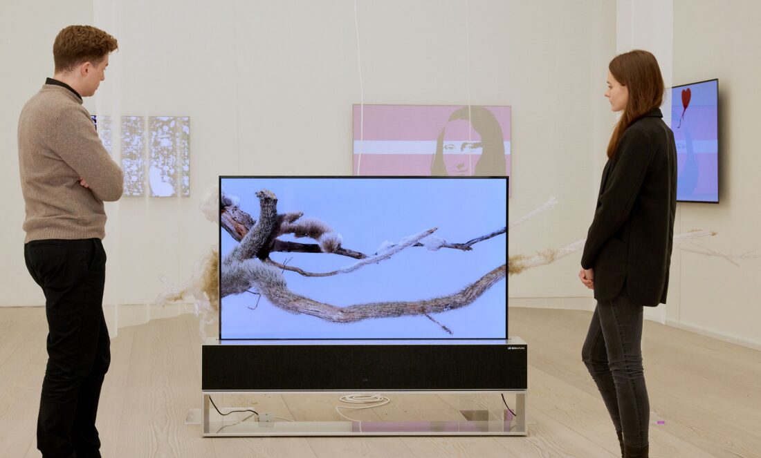 Two visitors viewing 'The Warm Tree' by Ruofan Chen