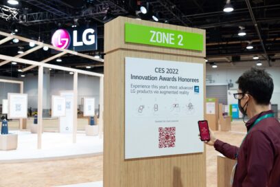 A visitor at LG's booth checking out a QR code on one of the displays