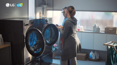 Two consumers are examining LG washer and dryer pair
