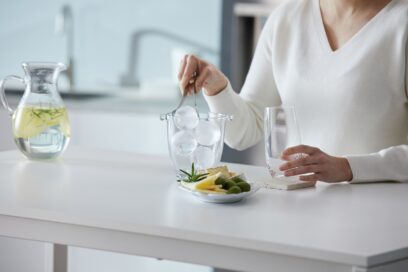 A woman using LG’s spherical Craft Ice balls while preparing a drink.