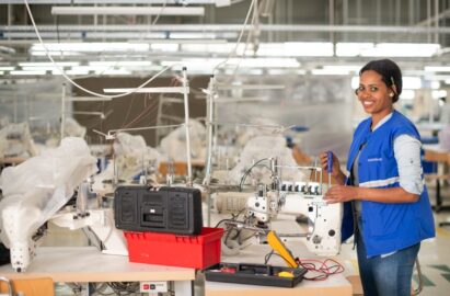 A trainee repairing a machine at a factory