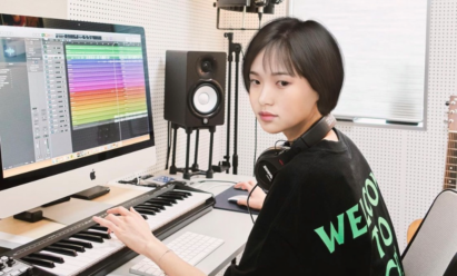 Reah Keem editing her music on a computer.