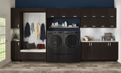 LG’s new AI DD washer and dryer set placed side by side in a room of wooden cabinet interior and hardwood floor.