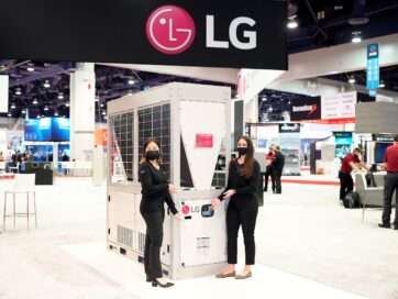 Two models posing with LG HVAC appliance below LG logo