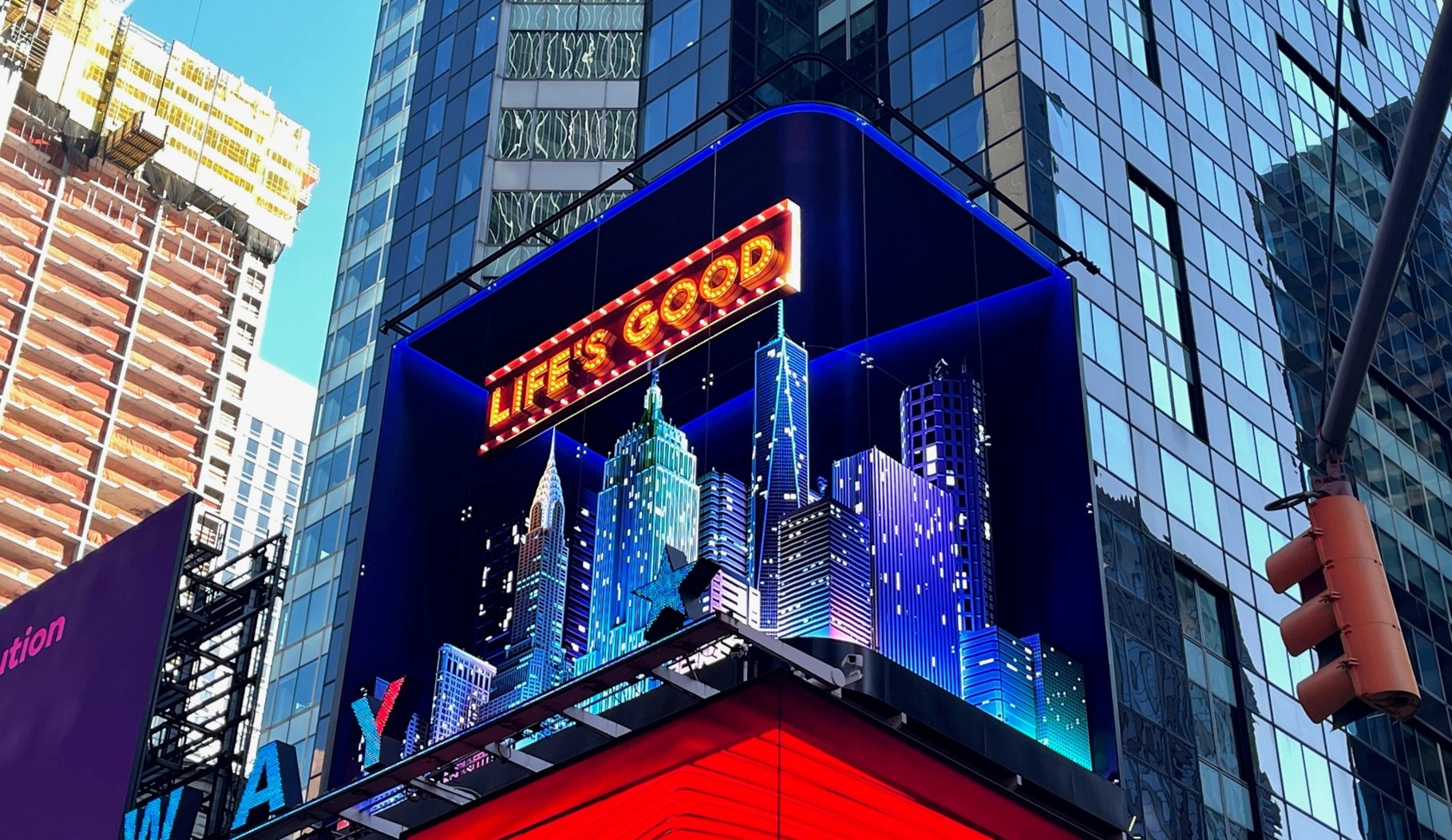 LG's digital billboard in Time Square, New York displaying an illustration of NYC with the phrase 'Life's Good'